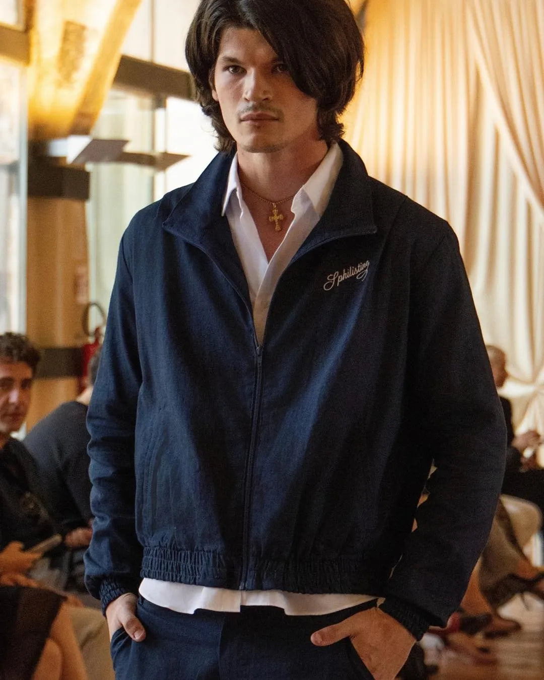 SPHILISTINE model wearing a navy tracksuit look from the SS27 Milan Fashion Week presentation